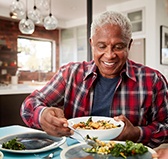 Man preparing to eat a meal with his dentures