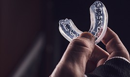 Patient holding clear mouthguard