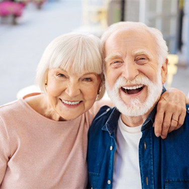 Couple smiling after dental implant post-op instructions in Merrimack 