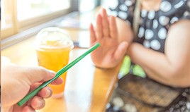 Woman saying no to being offered a straw 